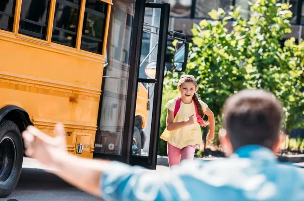 child at bus stop
